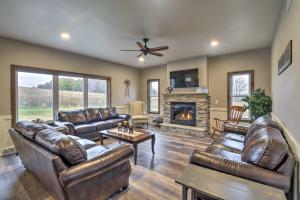 a living room with leather furniture and a fireplace at Lakefront Wisconsin Dells Home with Game Room in Wisconsin Dells