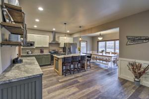 an open kitchen and dining room with a dining table at Lakefront Wisconsin Dells Home with Game Room in Wisconsin Dells