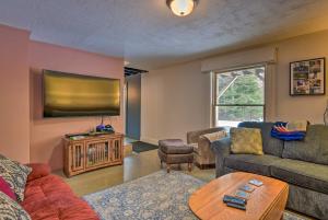 a living room with a couch and a tv at Darling Hill Home on Kingdom Trails-Near Burke Mtn in Lyndon