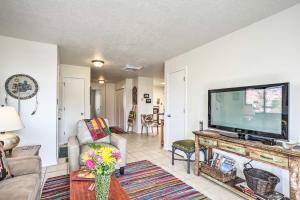 a living room with a large flat screen tv at Mountain-View Albuquerque Townhome with Patio! in Albuquerque