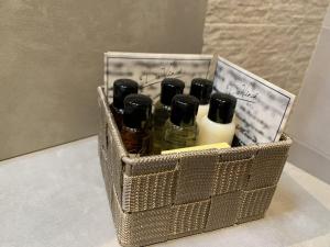 a basket filled with bottles of liquid on a table at OTTO AGRITURISMO in Ottobiano