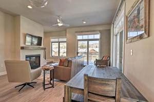 a living room with a table and a couch at Downtown Winter Park Condo - 3 Miles to Ski Resort in Winter Park