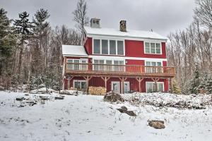 een rood huis met een terras in de sneeuw bij Architect-Designed Retreat on 2 Acres with Mtn Views in Franconia