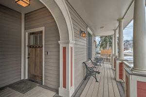 a porch with a bench and a door on a house at Updated Townhome with Hot Tub - Walk to Downtown! in Red Lodge