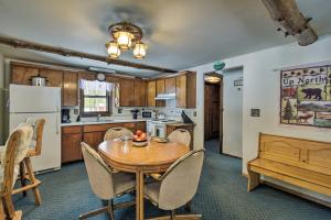 a kitchen and dining room with a wooden table and chairs at Cabin Near to Lakes, ATVing, Skiing and Natl Forest in Pound