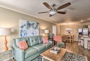 a living room with a couch and a ceiling fan at Port Aransas Condo with Pool Access Walk to Beach! in Mustang Beach
