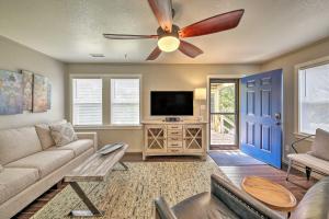 a living room with a couch and a ceiling fan at Cozy Cottage Less Than 2 Mi to Cape Hatteras Natl Shore! in Frisco