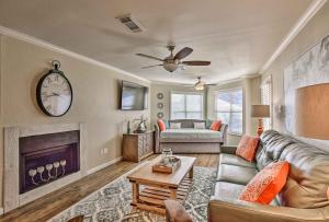 a living room with a couch and a fireplace at Port Aransas Condo with Pool Access Walk to Beach! in Mustang Beach