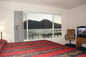 a bedroom with a bed and a large window at Lake Marina Inn in Clearlake Oaks