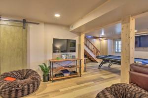 a living room with a pool table and a room with a pool table at Luxe Cabin with Hot Tub on 5 Acres in Pearcy! in Pearcy