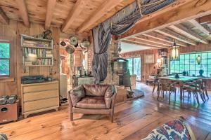 a living room with a couch and a table at Berkshire Riverfront Ski Cabin: Close to Hiking! in Mill River +23 photos