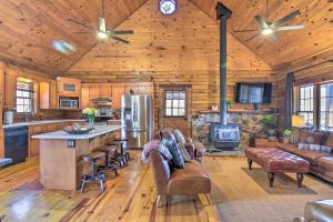 a kitchen and living room in a log cabin at Luxury Log Cabin with 5 Private Acres and Hot Tub! in Pearcy
