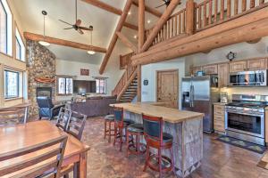 a kitchen and living room with a wooden ceiling at Private 1-Acre Lakeside Escape with Wraparound Deck in Lake of the Woods