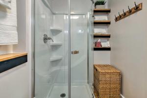 a shower with a glass door in a bathroom at Puget Sound Escape Private Beach and Oversized Deck in Kingston +34 photos