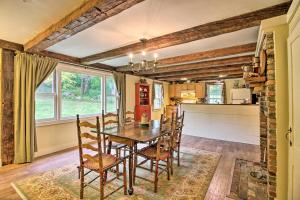 a kitchen and dining room with a wooden table and chairs at Historic Hanover Area Home, 16 Miles to Dartmouth! in Enfield
