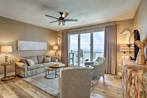 a living room with a couch and a ceiling fan at Resort Pool, Gym & Hot Tub: Beachfront PCB Condo! in Panama City Beach