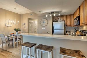 a kitchen and dining room with a counter and a refrigerator at Resort Pool, Gym & Hot Tub: Beachfront PCB Condo! in Panama City Beach