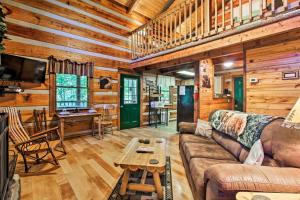 a living room with a couch and a table at Secluded Forest Cabin, 4 Mi to Downtown Gatlinburg in Gatlinburg