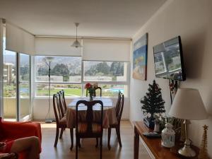 a dining room with a table and a christmas tree at Lomas Papudo 4 in Papudo