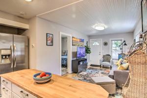a kitchen and living room with a couch and a table at Colorado Springs Bungalow - Walk to Downtown! in Colorado Springs