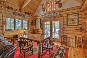 a dining room with a table and chairs in a cabin at Waterfront Conway Vacation Rental with Deck! in Conway
