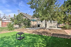 a yard with a grill in front of a house at Colorado Springs Bungalow - Walk to Downtown! in Colorado Springs