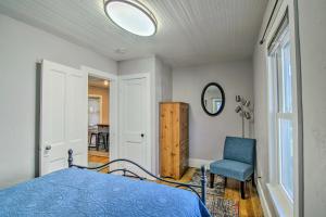 a bedroom with a bed and a chair and a mirror at Colorado Springs Bungalow - Walk to Downtown! in Colorado Springs