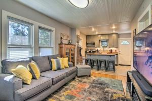 a living room with a couch and a kitchen at Colorado Springs Bungalow - Walk to Downtown! in Colorado Springs