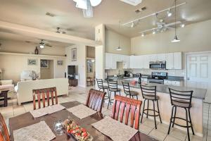 a kitchen and living room with a table and chairs at Bullhead City Home Tesla Charger about 3 Mi to River in Bullhead City