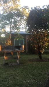 un edificio con una mesa en un campo con un árbol en Las Casitas de Sigi en San José