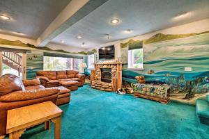 a living room with a couch and a fireplace at Under the Sea and Ski Apt with View, 7 Mi to Dwtn in Salt Lake City