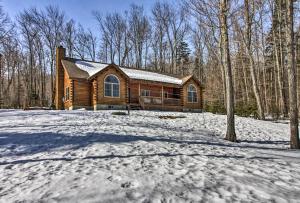 a log cabin in the snow with a driveway at West Dover Cabin with Game Room, 4 Mi to Mt Snow! in West Dover