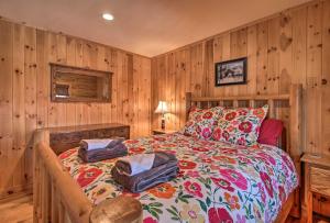 a bedroom with a bed with wood paneled walls at West Dover Cabin with Game Room, 4 Mi to Mt Snow! in West Dover