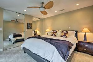 a bedroom with a large bed and a mirror at Salt Lake City Home with Koi Pond and Furnished Deck! in Salt Lake City