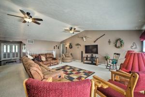 a living room with a couch and a tv at Pet-Friendly, Lakefront Home in Golden with Patio! in Golden