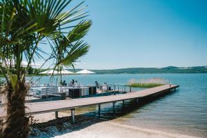 a dock on a lake with people on it at Insel der Sinne Naturhotel in Görlitz