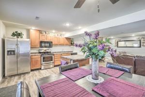 een keuken met een tafel met daarop een vaas met bloemen bij Kimberlys Hope Clark Apt on Farm with Pool Access in Clark