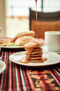 a plate with a stack of pancakes on a table at Casona Plaza Hotel Colonial in Arequipa