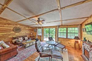 a living room with a couch and a table at Getaway on Center Hill Lake with Decks and Water Views in Silver Point
