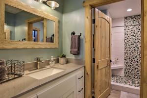 a bathroom with a sink and a mirror and a shower at Truckee Family Home, Walk to Lake and 5 Mi to Skiing in Truckee