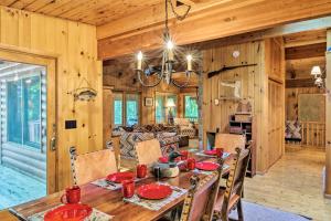 a dining room with a table and a living room at Rustic Cozy Cabin on Island Lake with Fire Pit, Dock in Arago