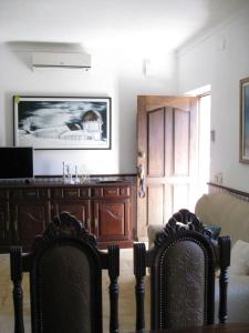 a living room with two chairs and a tv at Quinta Souto da Ordem - House in Castelo Novo