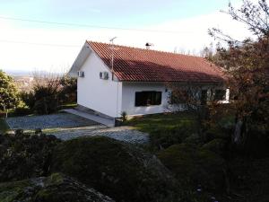 a small white house with a red roof at Quinta Souto da Ordem - House in Castelo Novo