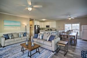 a living room with couches and a dining room and kitchen at Spacious Murrells Inlet Hub with Pool, Walk to Shore in Myrtle Beach