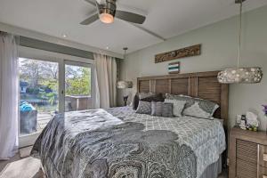 a bedroom with a large bed and a window at Luxury Hamptons Home on Canal with Dock and Kayaks! in East Quogue