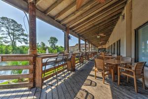 a patio with tables and chairs on a deck at Coastal Condo with Balcony and Luxe Resort Amenities! in Hilton Head Island