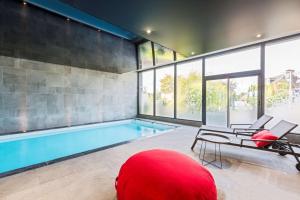 a large swimming pool with a red ball in a room at Best Western Plus Europe Hôtel Brest in Brest