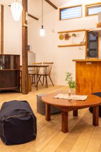 a living room with a coffee table and a kitchen at back alley residence Hibi in Osaka