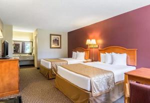 Llit o llits en una habitació de The Parkwood Inn & Suites