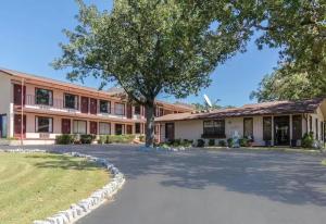 a large building with a tree in front of it at The Parkwood Inn & Suites in Mountain View